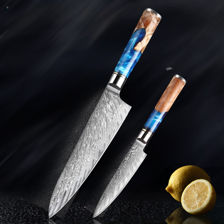 Ensemble de deux couteaux japonais de chef en acier de Damas avec un citron coupé en bas à droite sur fond noir